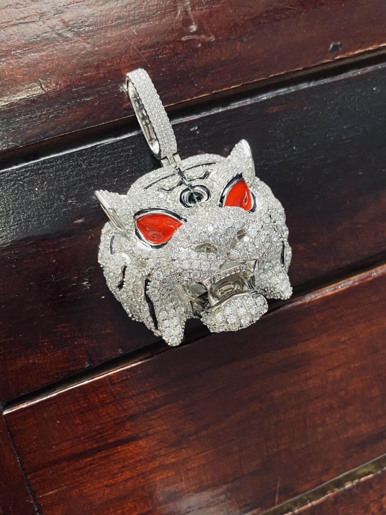 Diamond-encrusted red-eyed leopard head pendant